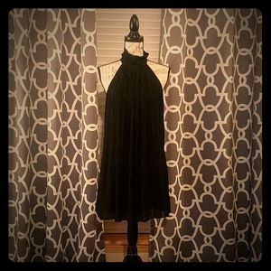 Black high neck pleated dress.